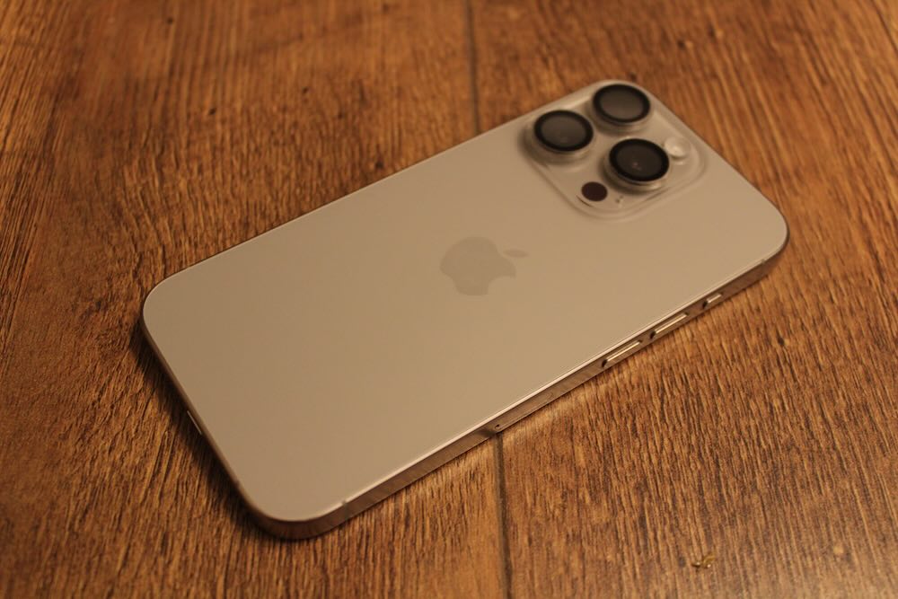 The back of the iPhone 15 Pro is glass but the protruding cameras are still there