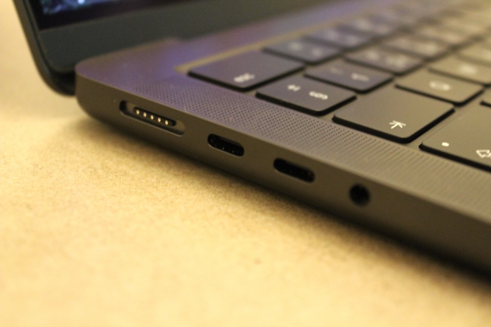 The left side of the MacBook Pro features a MagSafe 3 connector, two USB-C ports and a headphone jack